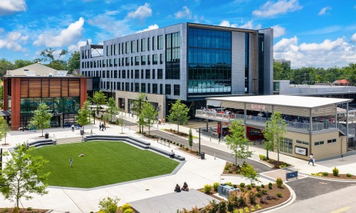 a courtyard with people and a dining area