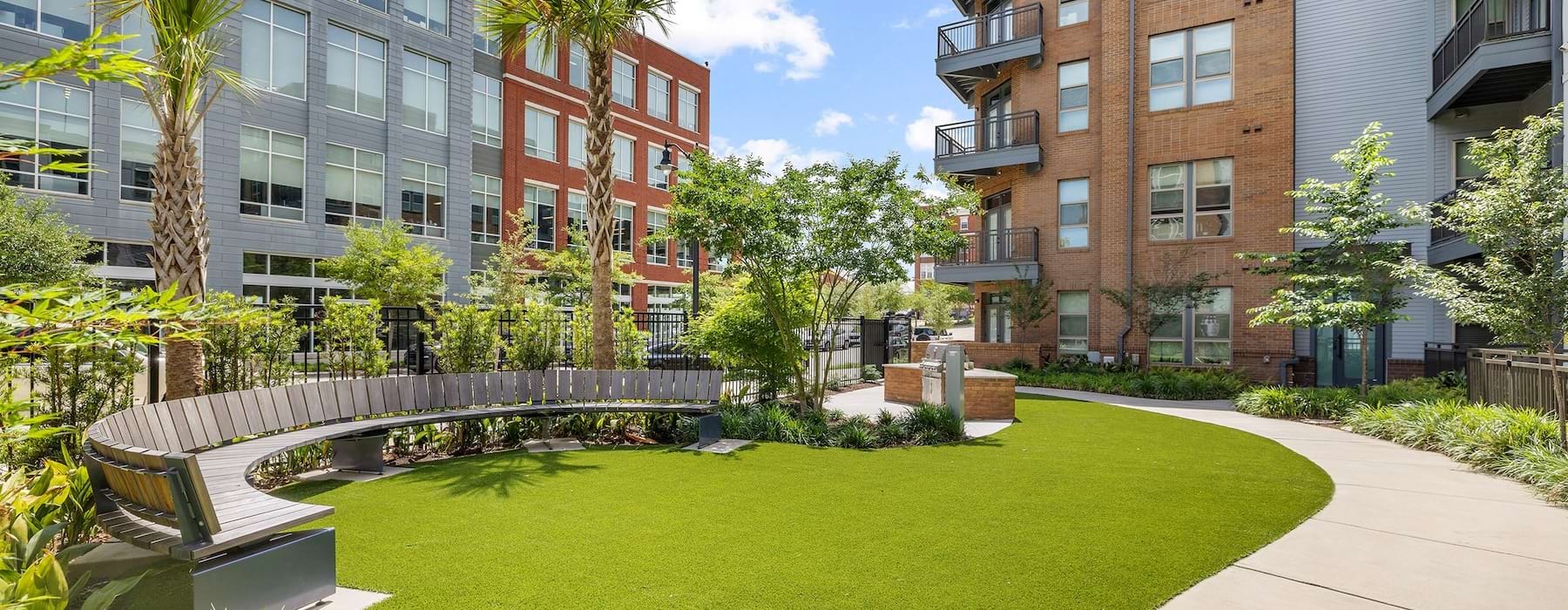 a seating area near grills and on a green lawn