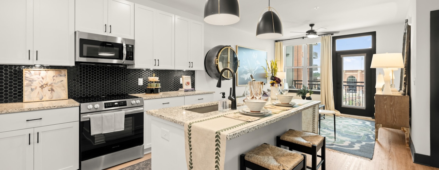 Kitchen and living room with furniture and patio door 