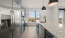 Kitchen with refrigerator,  island, and stainless steel appliances 